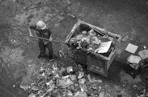 Van loading commercial waste outside a Seven Sisters high street shop